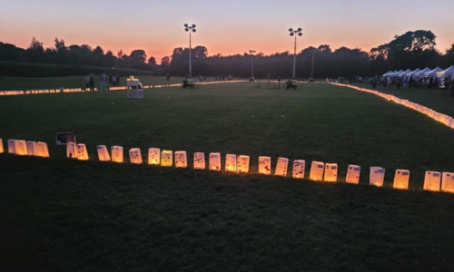 Candles in bag at a dusk backdrop on a field